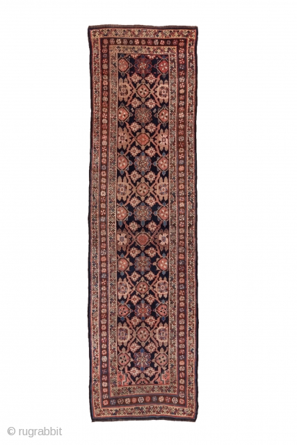 Kurd Runner

3.2 x 11.3
0.97 x 3.44

A chunky Mina Khani design of rosettes and smaller flowers closely covers the navy field of this all wool tribal runner. The ochre minor borders with their  ...