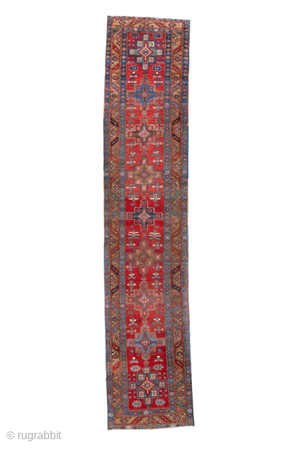 Antique Persian Heriz Runner, circa 1920. Featuring a classic geometric medallion design on a rich red field with indigo and ivory accents, framed by a traditional Heriz border. Durable village weave, ideal  ...