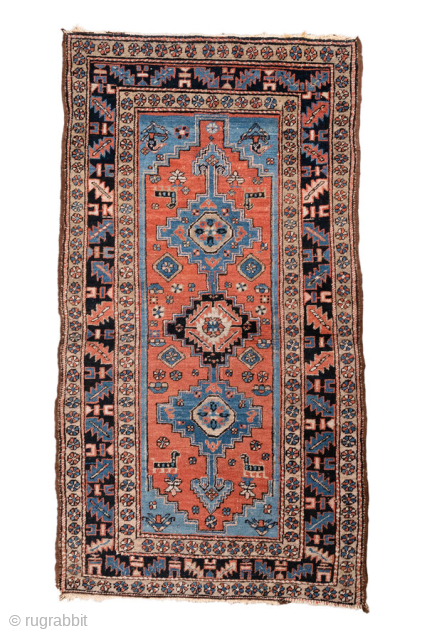 Antique Persian Heriz Rug, circa 1910. Featuring geometric medallions on a warm coral field with soft blue and ivory accents, framed by a bold tribal border. Classic Northwest Persian village design with  ...