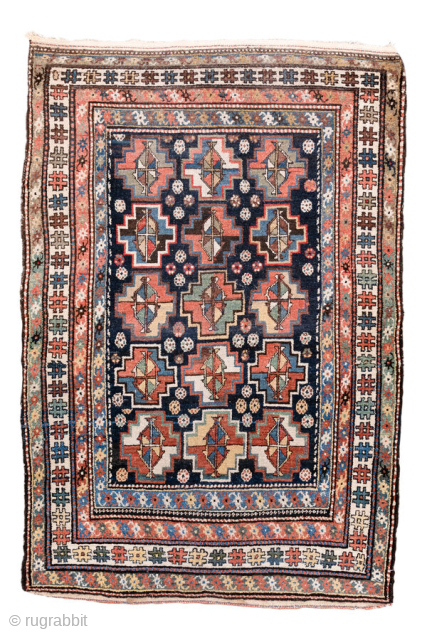 Antique Persian Kurdish Rug, circa 1920. Featuring an allover geometric medallion pattern on a deep indigo field with soft coral and ivory accents, framed by multiple tribal borders. Bold village weaving with ...