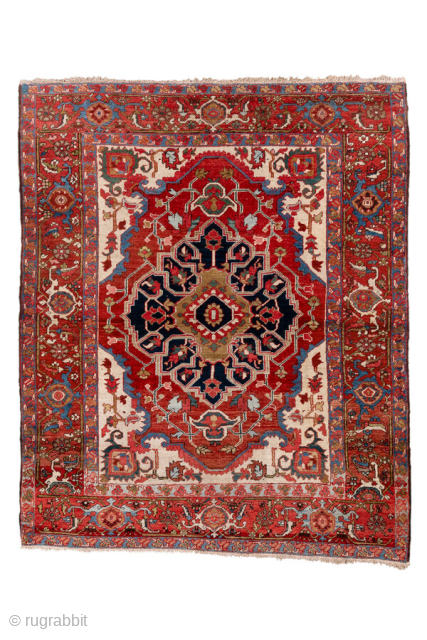 Antique Persian Serapi Rug, circa 1900. Featuring a bold geometric medallion on an ivory field with rich red and deep indigo accents, framed by a classic Heriz-style border. Strong Northwest Persian design  ...