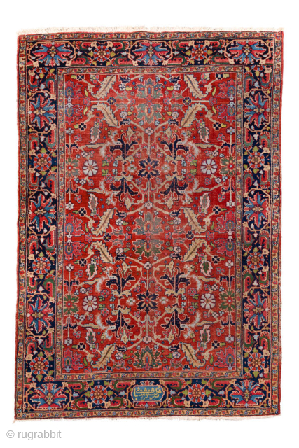 Antique Persian Heriz Rug, circa 1900. Featuring an allover floral design on a rich red field with deep indigo and ivory accents, framed by a classic Heriz border. Bold Northwest Persian weaving  ...