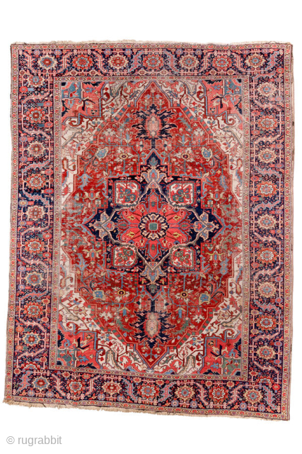 Antique Persian Heriz Carpet, circa 1900. Featuring a dramatic geometric medallion on a rich red field with deep indigo and ivory accents, framed by a classic Heriz border. Bold Northwest Persian design  ...