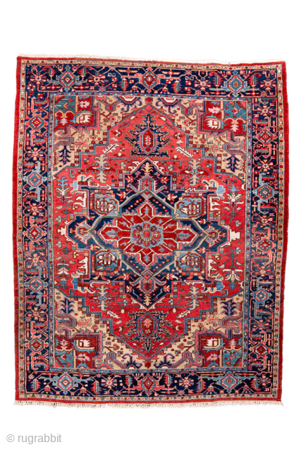 Antique Persian Heriz Rug, circa 1900. Featuring a bold geometric medallion on a vibrant red field with deep indigo and ivory accents, framed by a classic angular Heriz border. Strong Northwest Persian  ...