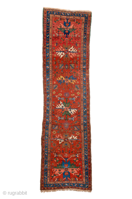 Antique Persian Heriz Runner, circa 1910. Featuring bold geometric medallions on a vibrant red field with blue and ivory accents, framed by a classic Heriz border. Strong Northwest Persian village design with  ...