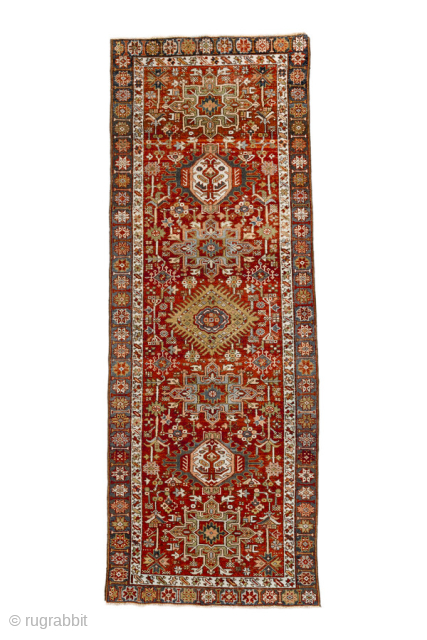 Antique Persian Heriz Runner, circa 1910. Featuring a series of bold geometric medallions on a rich red field with soft blue and ivory accents, framed by a classic Heriz border. Strong Northwest  ...