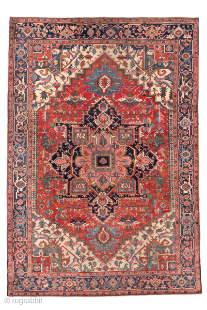 Antique Persian Heriz Carpet, circa 1900. Featuring a bold geometric medallion on a vibrant red field with deep indigo and ivory accents, framed by a classic Heriz border. Strong Northwest Persian design  ...