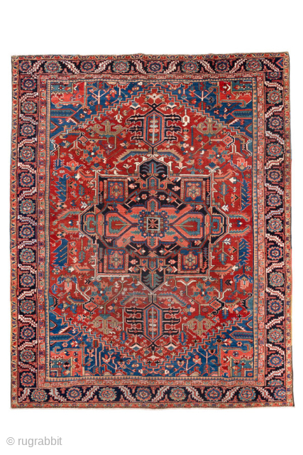 Antique Persian Heriz Carpet, circa 1900. Featuring a bold geometric medallion on a vibrant red field with deep indigo and ivory accents, framed by a classic Heriz border. Strong Northwest Persian design  ...