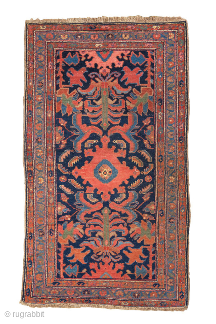 Antique Persian Malayer Rug, circa 1920. Featuring a bold, stylized medallion and angular floral motifs on a deep navy field with warm rust and soft blue accents, framed by a classic Heriz-inspired  ...