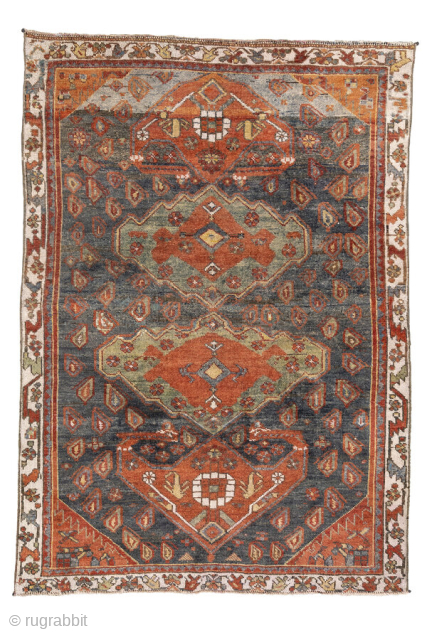 Antique Kurdish Rug, circa 1920. Featuring bold geometric medallions on a softly abrash blue-gray field with warm rust, ivory, and soft green accents, surrounded by a lively tribal border.

Item No. 101578

4'4" x  ...