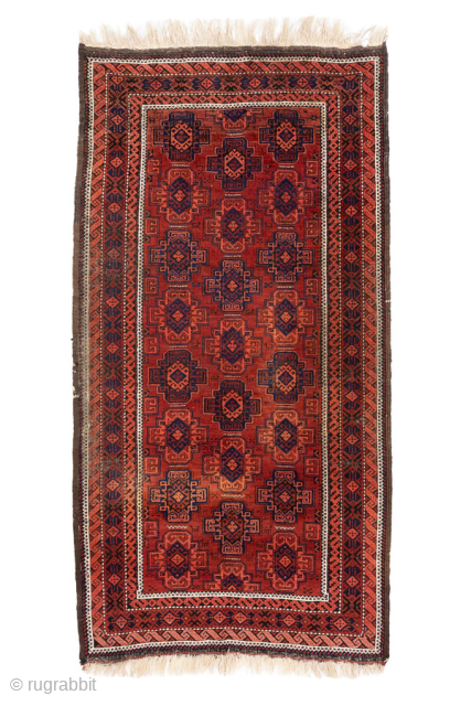 Antique Belouch Rug, circa 1920. Featuring repeating geometric guls on a rich red field with deep navy accents, framed by multiple narrow tribal borders. Compact, finely drawn design with classic Baluch character.

Item  ...