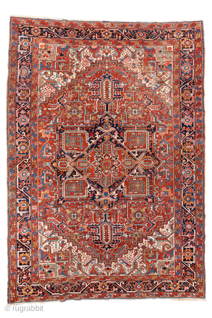 Antique Persian Heriz Rug, circa 1900. Featuring a striking geometric medallion on a vivid rust-red field with deep navy and ivory accents, framed by a bold angular border characteristic of Northwest Persian ...