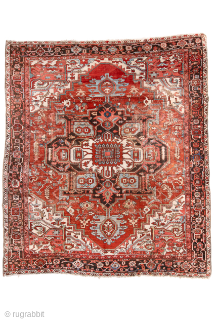 Antique Persian Serapi Rug, circa 1900. Featuring a monumental geometric medallion on a richly abrashed red field with ivory and deep brown accents, framed by a bold tribal border. Powerful drawing, spacious ...