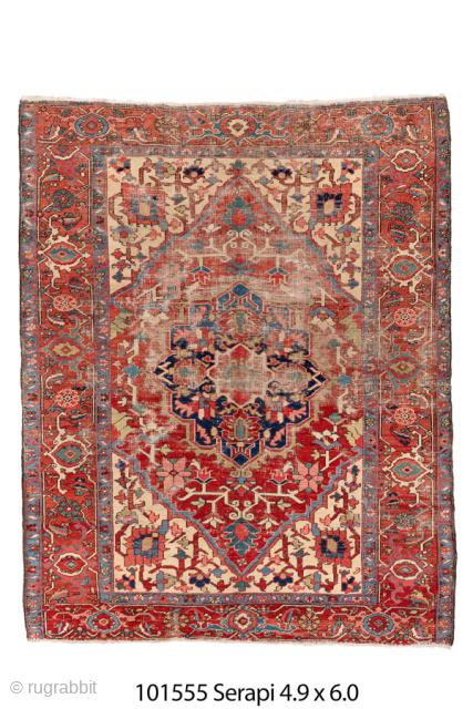Antique Persian Serapi Rug, Circa 1900. Bold geometric medallion set within an age-softened ivory field surrounded by vibrant red and blue borders. Combination of expressive drawing, age-softened patina, and strong tribal ornamentation  ...