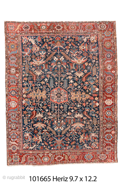 Antique Persian Heriz Carpet, Circa 1900. Richly detailed allover design woven across a deep navy field and framed by a vibrant coral-red border. Strong tribal drawing, saturated natural dyes, and expansive decorative  ...