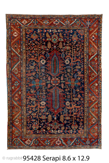 Antique Persian Serapi Carpet, Circa 1900. Features a deep midnight-blue field filled with stylized botanical motifs and twin elongated geometric medallions framed by a vibrant rust-red border.

8'6" x 12'9"

Item No: 95428  