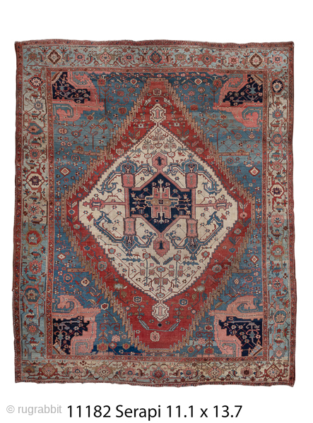 Antique Persian Serapi Carpet, Circa 1900. Striking ivory diamond medallion floating on a luminous sky-blue field with bold geometric detailing throughout.
11'1" x 13'7"
Item No:11182