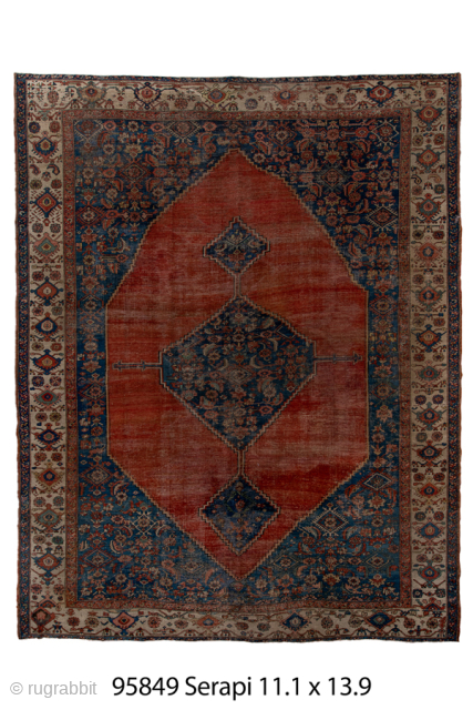 Antique Persian Serapi Carpet, Circa 1900. Dramatic oversized salmon-red medallion set against a richly detailed indigo field and framed by an elegant ivory border.
11'1" x 13'9"
Item No: 95849