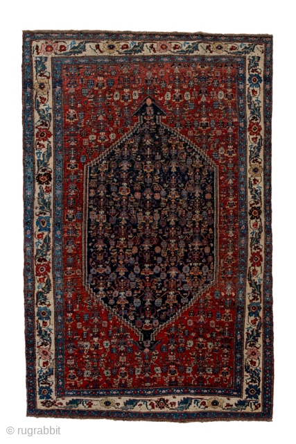 Antique Persian Bidjar Carpet, Circa 1920. Richly detailed midnight blue Herati medallion set within a terracotta field and framed by an elegant ivory turtle-palmette border.
4'10" x 7'7"
Item No: 95952