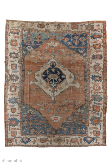 Antique Persian Serapi Carpet, Circa 1900. Features a spacious terracotta field with a striking geometric medallion and softly faded blue spandrels framed by an elegant ivory border.
10'3" x 12'7"
Item No: 97751