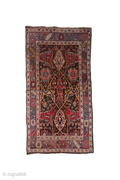 Antique Persian Bidjar Carpet, Circa 1920. Striking tribal composition with three elongated latch-hook medallions surrounded by bold geometric motifs woven in rich crimson and deep indigo.
3'9" x 7'2"
Item No: 36872
