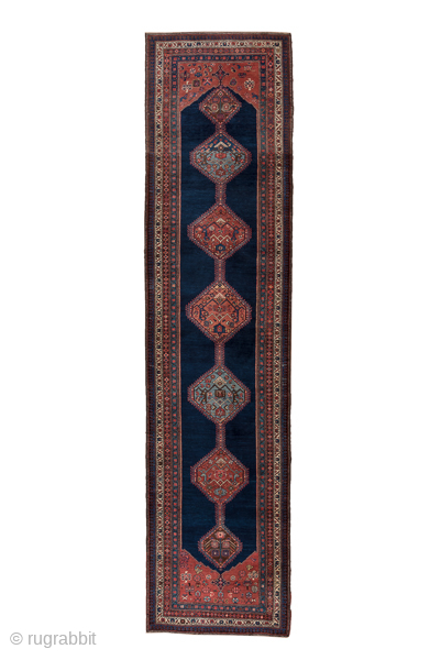Antique Persian Bidjar Runner, Circa 1900. Showcases a dramatic chain of geometric lozenge medallions woven across a deep midnight blue field framed by richly detailed terracotta borders.

3'7" x 15'0"

Item No: 74360  
