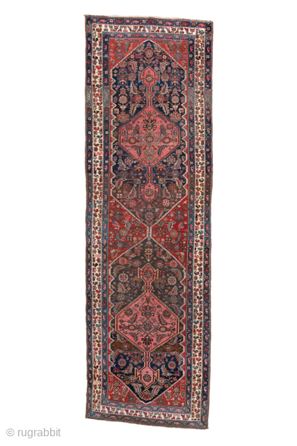 Antique Persian Bidjar Runner, Circa 1910. Bold series of geometric medallions woven across a deep midnight blue field framed by an elegant ivory floral border. 

3'4" x 10'10"

Item No: 99068   