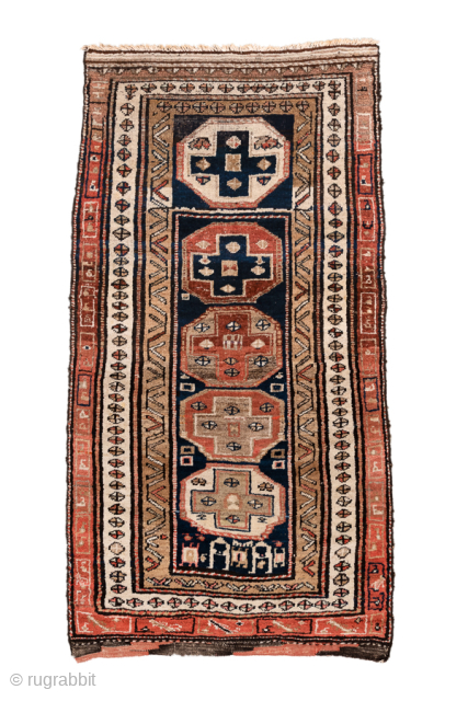 Antique Persian Kurdish Rug, Circa 1900. Bold geometric medallions woven across a rich midnight blue field framed by striking stepped tribal borders.
3'5" x 6'5"
Item No: 101337