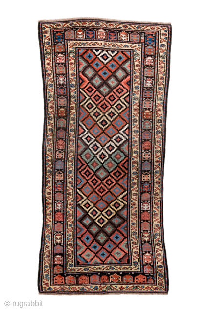Antique Persian Kurdish Rug, Circa 1900. Vibrant allover lattice of hooked diamond motifs woven across a rich midnight blue field framed by crisp ivory and geometric tribal borders.
3'1" x 6'10"
Item No: 101456