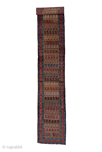 Antique Persian Bidjar Runner, Circa 1910. Refined allover lattice of repeating boteh motifs woven across a warm camel field framed by richly detailed midnight blue borders.
3'6" x 18'10"
Item No: C66490