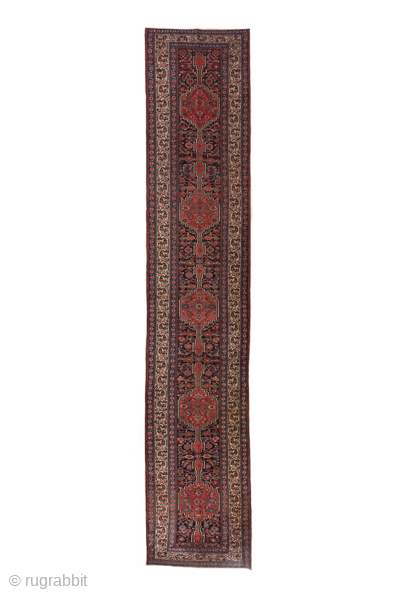 Antique Persian Bidjar Runner, Circa 1900. Graceful sequence of geometric medallions woven across a richly detailed Herati field framed by an elegant ivory floral border.

3'6" x 17'9"

Item No: C68739    