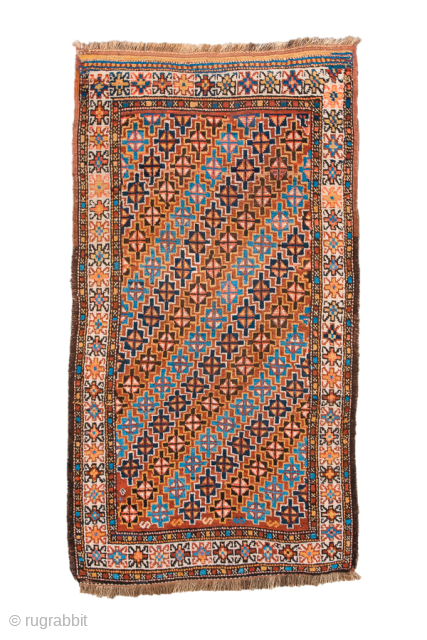 Antique Persian Kurdish Rug, Circa 1900. Vibrant allover lattice of geometric rosettes woven across a warm camel field framed by a crisp ivory floral border.
3'0" x 5'6"
Item No: 99752