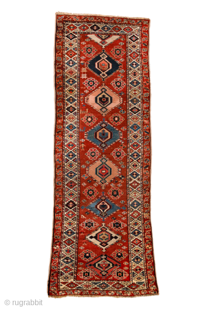 Antique Persian Kurdish Runner, Circa 1900. Features a striking sequence of geometric medallions on a rich madder-red field.
3'5" x 9'7"
Item No: 101344