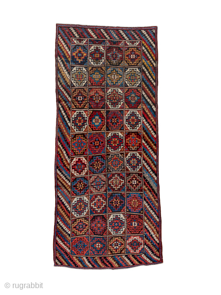 Antique Persian Kurdish Rug with Geometric Medallions, Circa 1900. Striking grid of individually patterned geometric medallions framed by a distinctive diagonal striped border.
4'5" x 10'3"
Item No: C21159