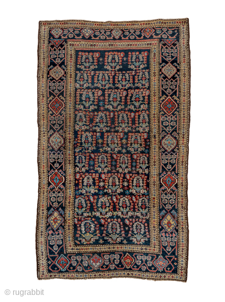 Antique Persian Kurdish Rug, Circa 1900. Richly woven allover Herati-inspired lattice framed by striking indigo borders filled with colorful geometric medallions.
4'8" x 8'0"
Item No: C90583