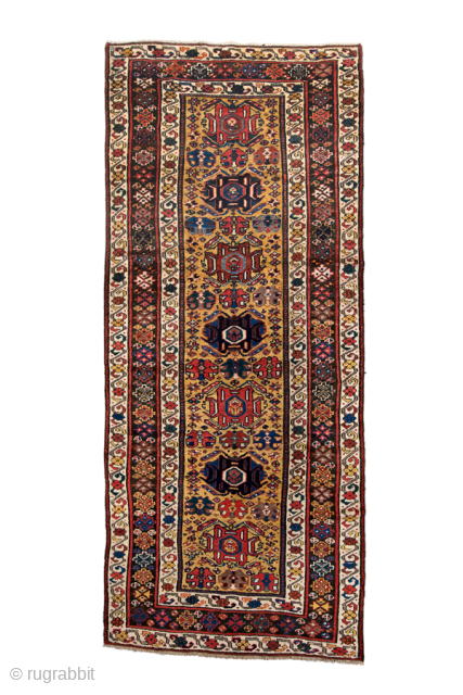 Antique Persian Kurdish Runner, Circa 1900. Features seven bold geometric medallions on a warm camel field surrounded by richly patterned borders.
4'4" x 10'4"
Item No: 97998
