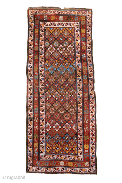 Antique Persian Kurdish Rug, Circa 1900. Finely detailed allover lattice of hooked diamond motifs woven across a warm camel-brown field framed by crisp ivory and madder-red tribal borders.

3'7" x 8'5"

Item No: 98530 
