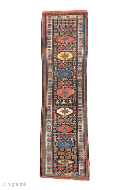 Antique Persian Kurdish Runner, Circa 1900. Succession of colorful geometric medallions surrounded by small tribal and figural motifs on a deep brown field.

3'6" x 12'5"

Item No: 99582      