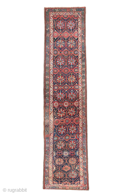 Antique Persian Kurdish Runner with Geometric Rosette Design, Circa 1900. features repeating octagonal rosettes arranged across a rich indigo field.
3'2" X 13'5"
Item No: 99604