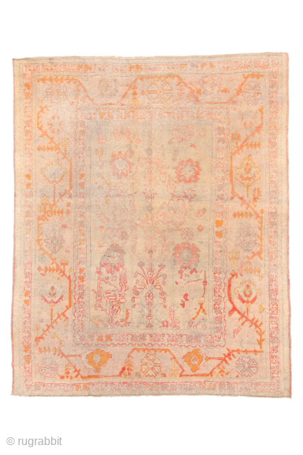 Item 99687 
8'10 x 10'9 

This charming antique Oushak rug features a soft, time-worn palette of blush, apricot, and golden tones that feel warm and inviting. Its open field is decorated with  ...