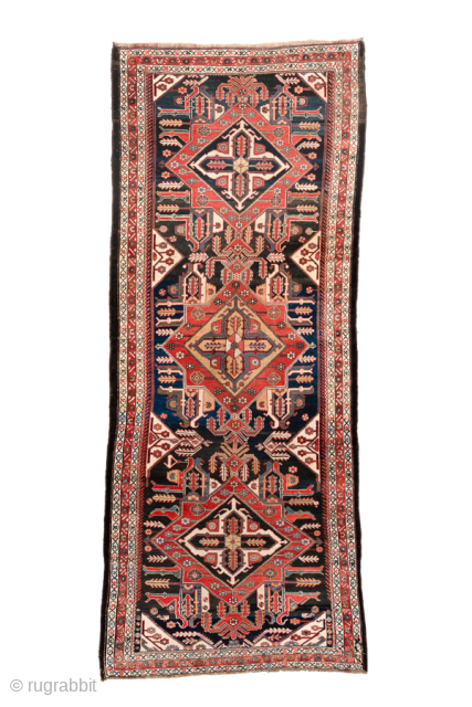 Antique Persian Bakhtiari Rug with Triple Medallion Design, Circa 1920. Features three bold geometric medallions surrounded by stylized tribal motifs on a deep navy field.
4'4" x 10'9"
Item No: 101773