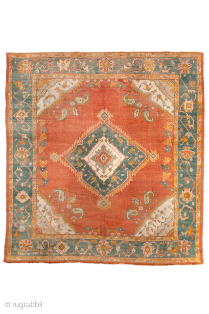 Antique Turkish Oushak Rug with Central Medallion, Circa 1900. Features a bold central medallion on a warm terracotta field, framed by ivory corner spandrels and a wide green floral border.
10'9" x 11'5"
Item ...