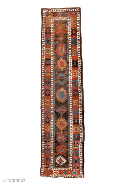 Antique Caucasian Kazak Runner with Geometric Medallions, Circa 1910. A succession of colorful geometric medallions across a dark field, surrounded by bold tribal borders.
3'6" x 13'6"
Item No: 102236