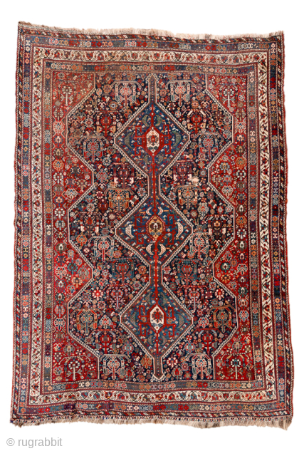 Antique Persian Shiraz Rug with Triple Diamond Medallions, Circa 1920. Features three bold diamond medallions surrounded by densely drawn tribal floral and geometric motifs.
Inventory no. 101343
6'9" x 9'5"