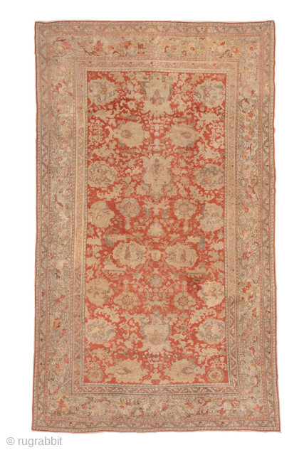 This antique Sivas rug from early 20th-century Turkey exudes timeless elegance with its intricate all-over floral design. Woven in a striking palette of warm coral, ivory, and soft beige, the rug balances  ...