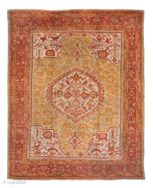 This large-scale antique Oushak rug from circa 1900 exemplifies the grandeur and artistry of Western Anatolian weaving. The warm golden field is centered by a bold, round medallion in shades of rust,  ...