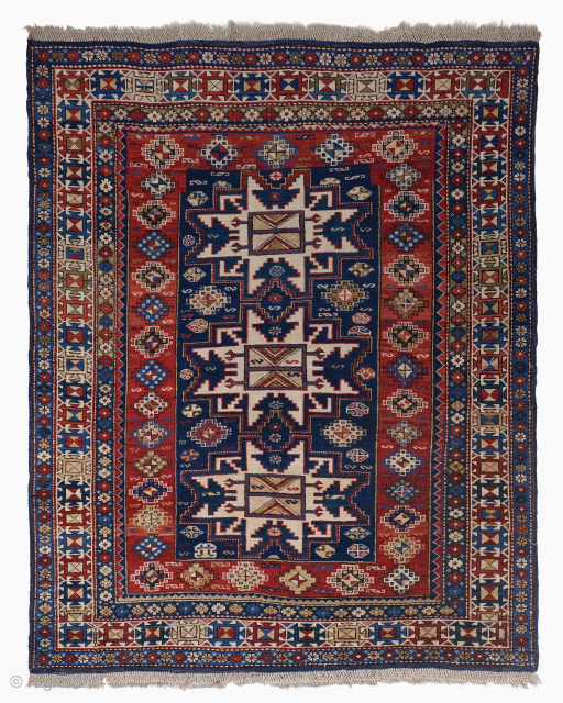 Period: Late 19th Century
Origin: Caucasus
Dimensions: 120 x 155 cm

This rare late 19th century Caucasian Lezgi Shirvan rug highlights a powerful and rhythmic geometric composition featuring a vertical sequence of three monumental, nested  ...