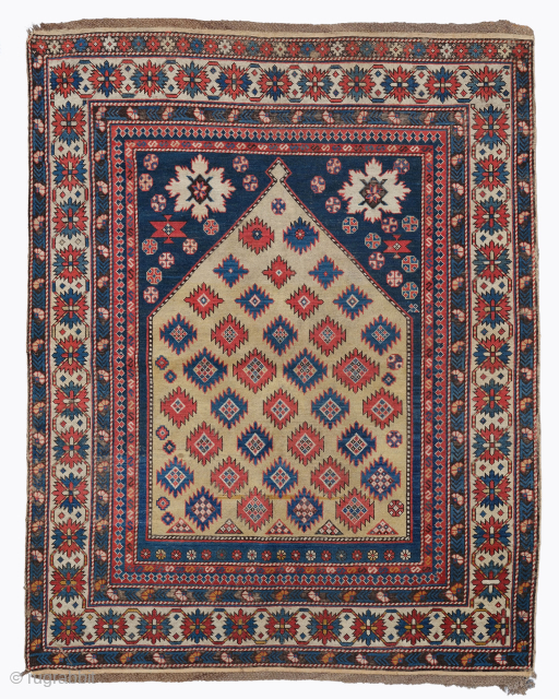 Period: Mid 19th Century
Origin: Shirvan
Dimensions: 135 x 165 cm

This rare mid 19th century Caucasian Shirvan Kuba prayer rug highlights a powerful and rhythmic geometric composition featuring a centralized ivory prayer niche anchored  ...