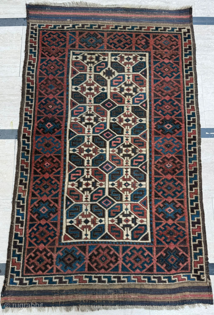 Middle of 19th Century North East Persia, Baluch Rug
In this Baluch rug of the head and shoulders type, the border is recessed at right angles in the upper section of the field,  ...