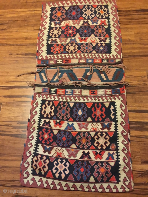 Antique kilim khorjin, Kurds of Varamin. 55” X 25-1/2”. Circa 1900. Good colors. Complete and in untouched original condition with intact edge wrapping and closure loops.       